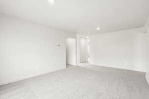 **DISCLAIMER** Interior color package may vary.Spare room with light colored carpet and recessed lighting