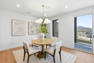 Dining area with light wood-type flooring, recessed lighting, a mountain view, and a chandelier