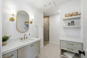Bathroom featuring vanity and a stall shower