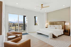 Bedroom with light wood-style floors, access to outside, a mountain view, ceiling fan, and recessed lighting