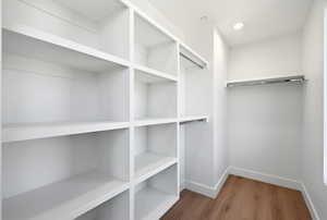 Spacious closet featuring light wood-type flooring
