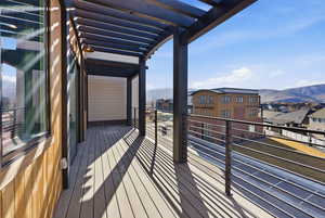 Wooden terrace featuring a mountain view, a residential view, and a pergola