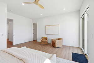 Bedroom with light wood-type flooring, a ceiling fan, and recessed lighting