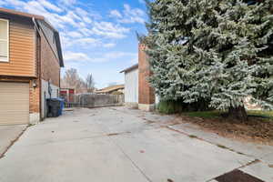 View of side of home with brick siding and concrete driveway