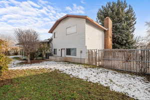 View of home's exterior featuring a chimney and a central AC unit