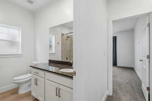 Bathroom featuring a tile shower and vanity