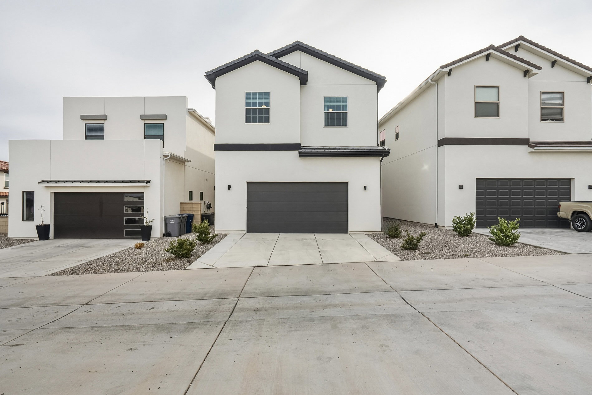 View of front of property featuring stucco siding, concrete driveway, and a garage