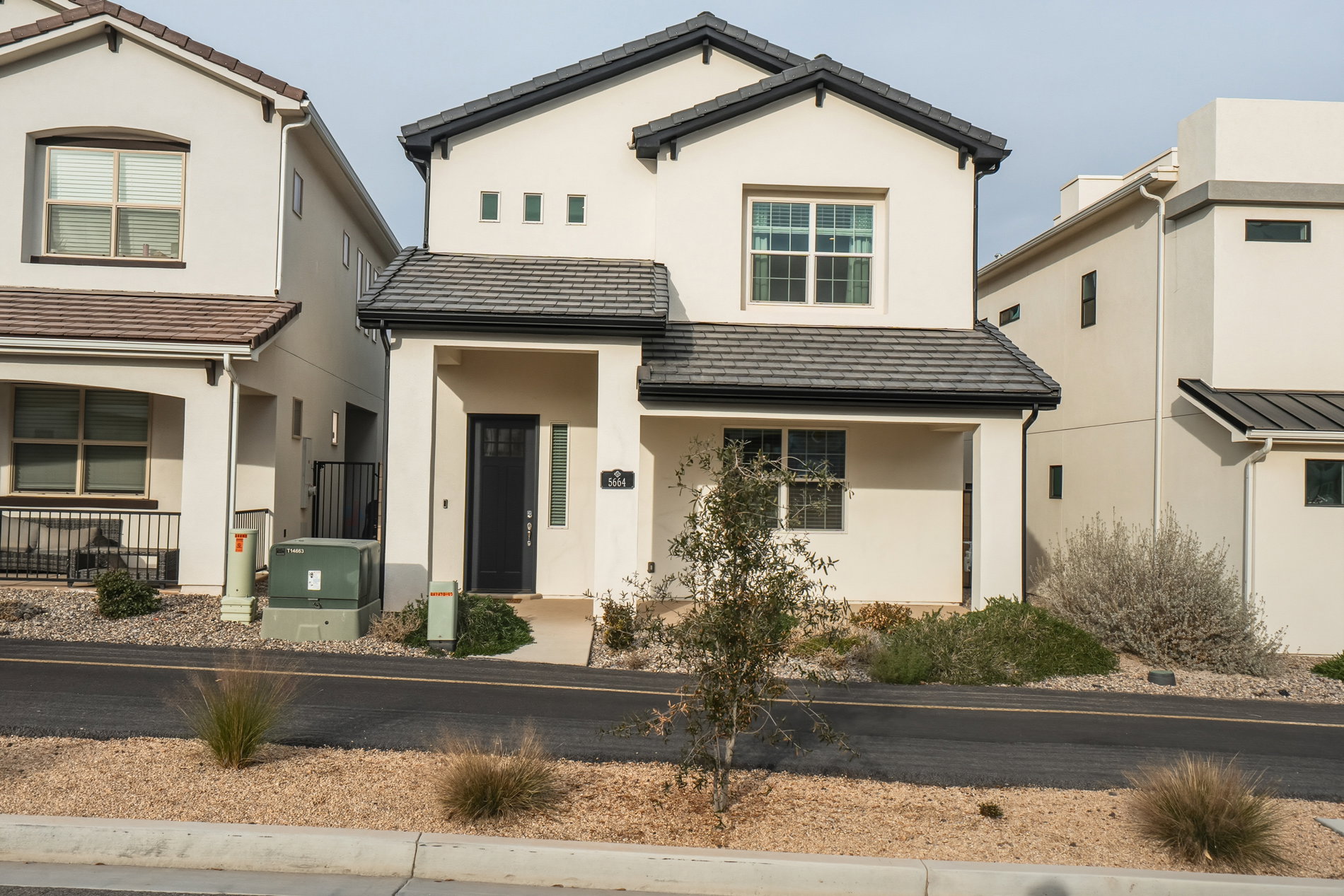 View of front of home featuring covered porch, stucco siding, and a tile roof
