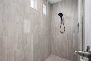 Full bath with a tile shower