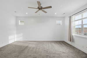 Empty room featuring carpet flooring, a ceiling fan, and recessed lighting