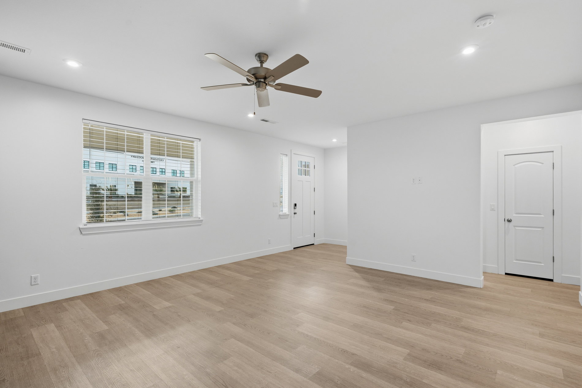 Unfurnished room featuring light wood-style flooring, a ceiling fan, and recessed lighting