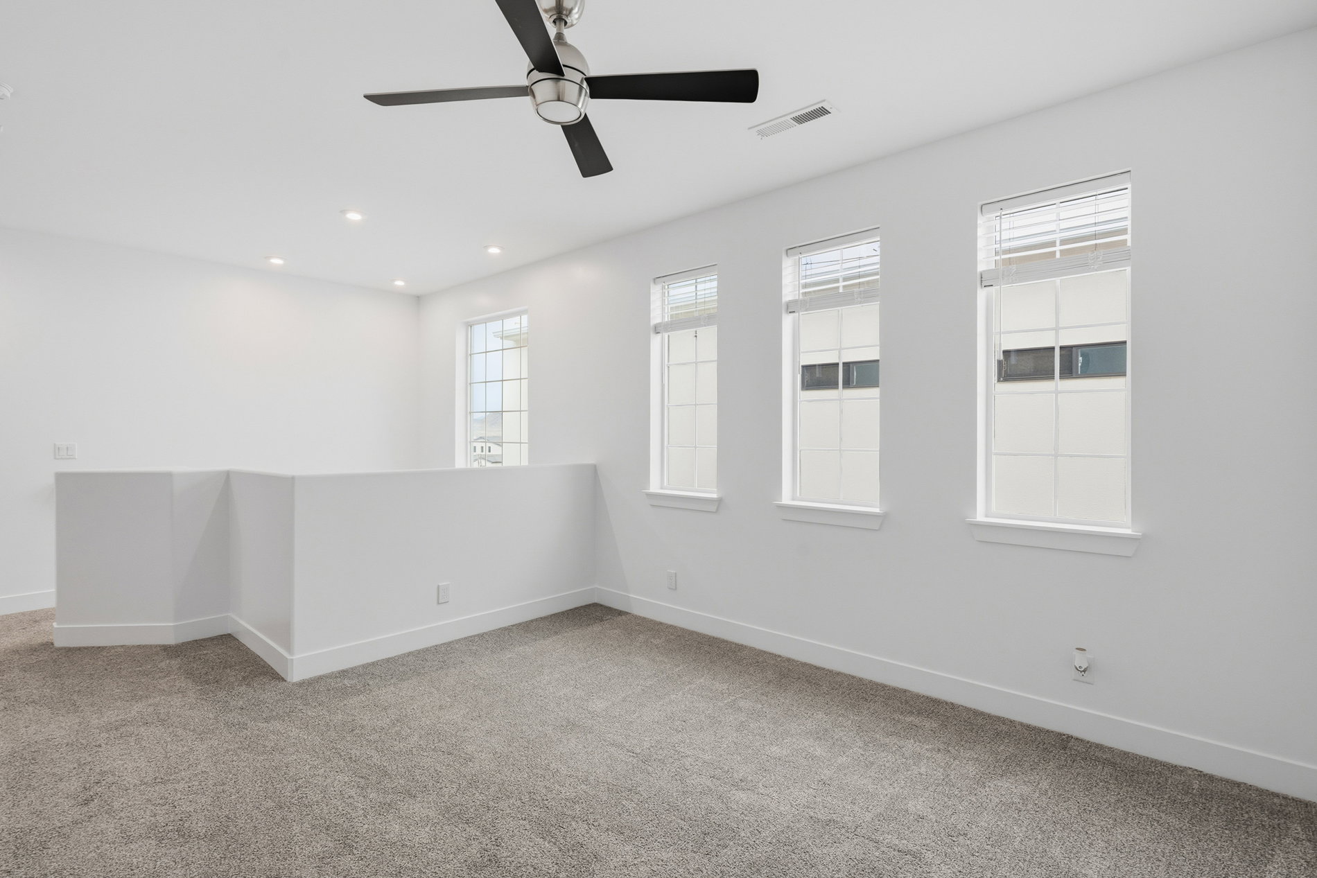 Spare room with light carpet, a ceiling fan, and recessed lighting