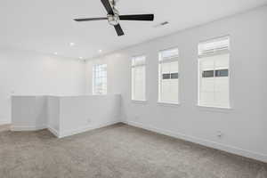 Spare room with light carpet, a ceiling fan, and recessed lighting