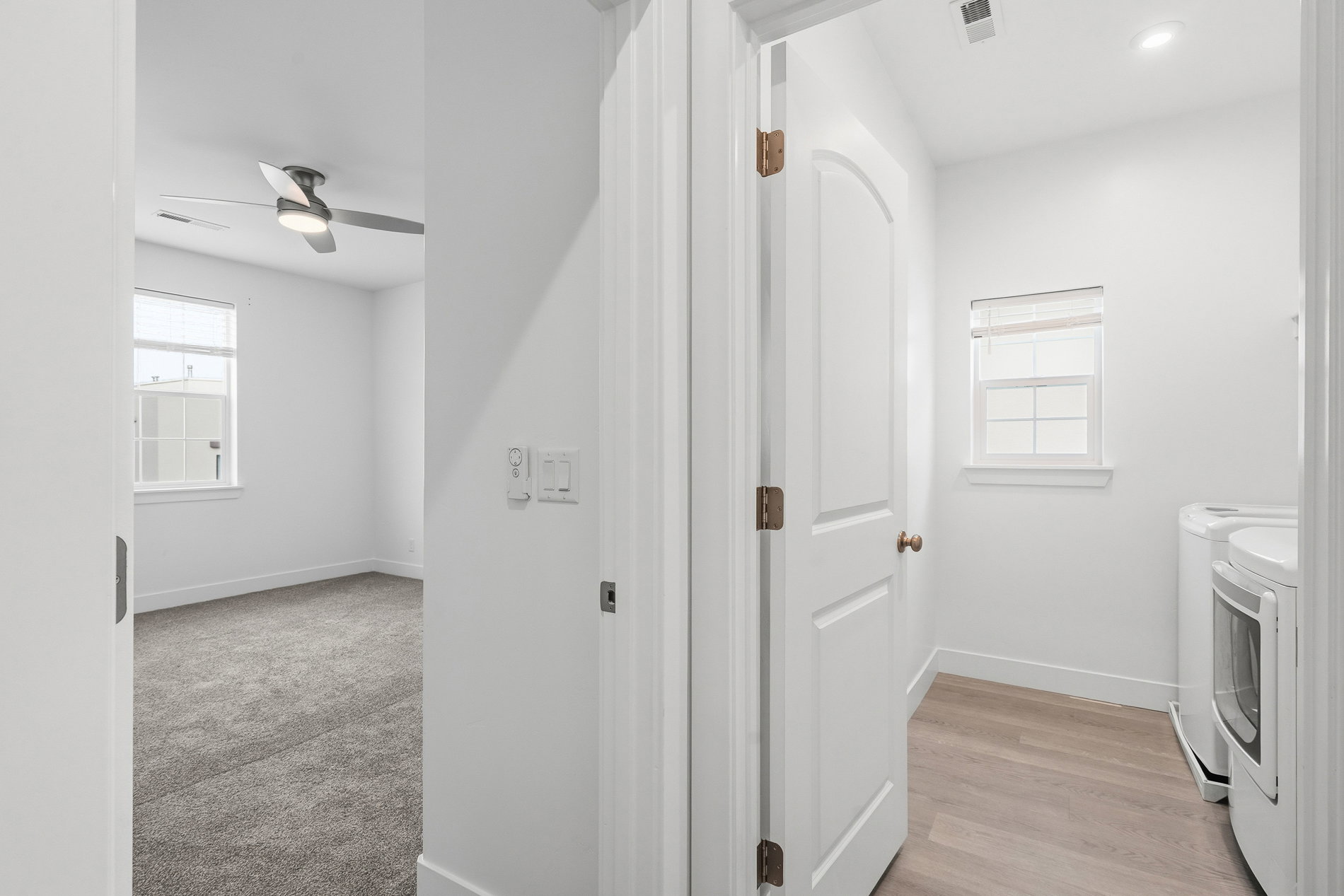 Washroom featuring washing machine and dryer, ceiling fan, light wood-style flooring, and recessed lighting