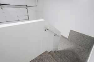 Stairs featuring baseboards and carpet flooring