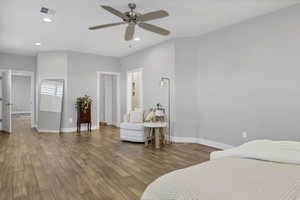 Bedroom featuring recessed lighting, wood finished floors, a ceiling fan, and a baseboard radiator