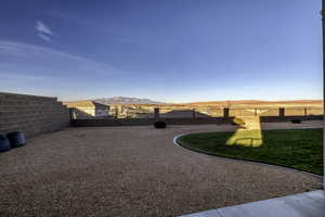 Fenced backyard featuring a mountain view