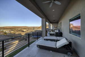 Balcony featuring ceiling fan and a residential view