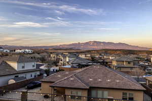 View of mountain backdrop featuring nearby suburban area
