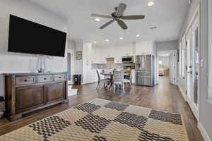 Living area featuring dark wood-style floors, recessed lighting, and ceiling fan