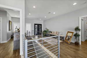 Foyer entrance with dark wood finished floors and recessed lighting
