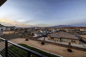 Balcony at dusk featuring a residential view