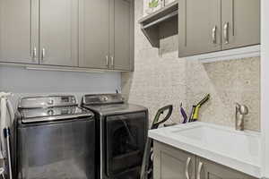 Laundry room with cabinet space and washer and dryer