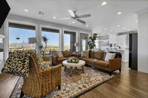 Living area featuring light wood-style floors, ceiling fan, a mountain view, and recessed lighting
