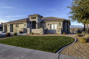 Mediterranean / spanish house featuring stone siding, stucco siding, and a tile roof