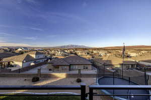 Fenced backyard featuring a residential view, a mountain view, and a balcony