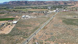 Aerial view of property's location featuring a mountain backdrop and rural landscape