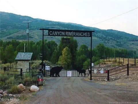 Surrounding community with a mountain view, a gate, and a view of countryside