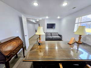Carpeted office featuring recessed lighting