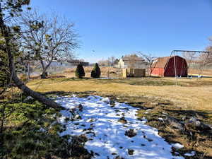 View of yard with an outdoor structure and a barn