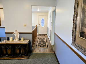 Entryway with crown molding and carpet flooring