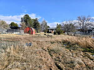 View of yard with an outdoor structure and a barn