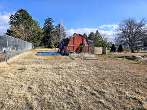 View of yard featuring a barn and an outdoor structure