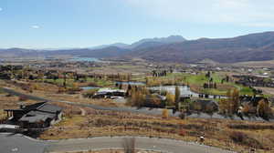 View of mountain background featuring a nearby body of water and nearby suburban area