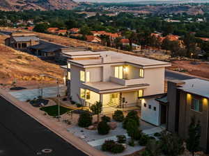 View of front of house with a mountain view, stucco siding, driveway, and a garage