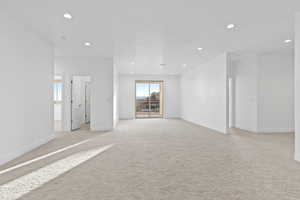 Unfurnished room featuring light colored carpet and recessed lighting