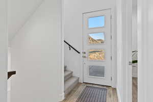 Entryway featuring wood finished floors and stairs