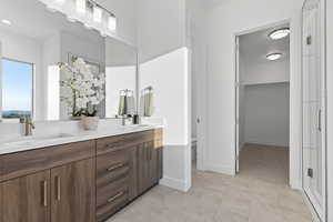 Full bath with double vanity and toilet