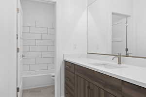 Bathroom featuring vanity, shower / washtub combination, and light tile patterned floors