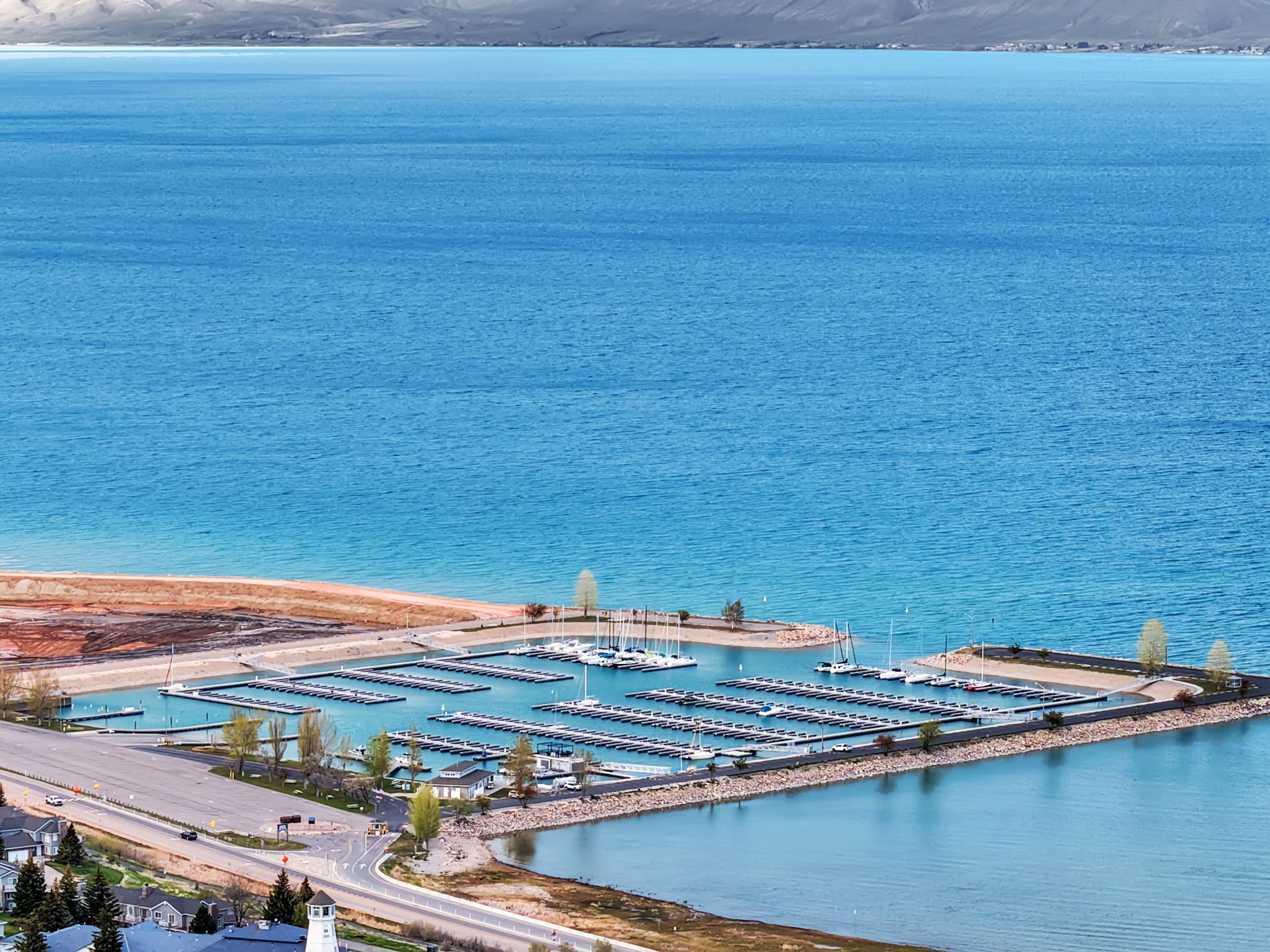 Expansive waterfront setting featuring a modern marina with numerous boat slips