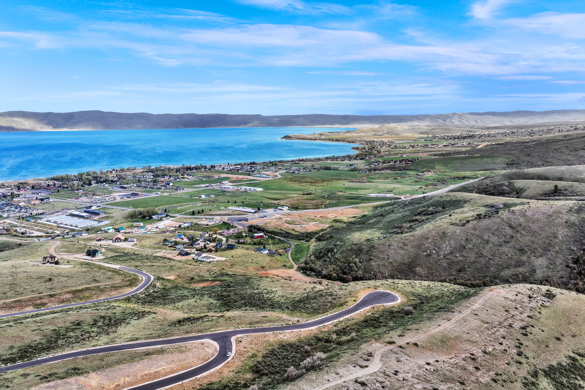 Expansive land parcel featuring natural topography, paved roadways, and partially developed areas