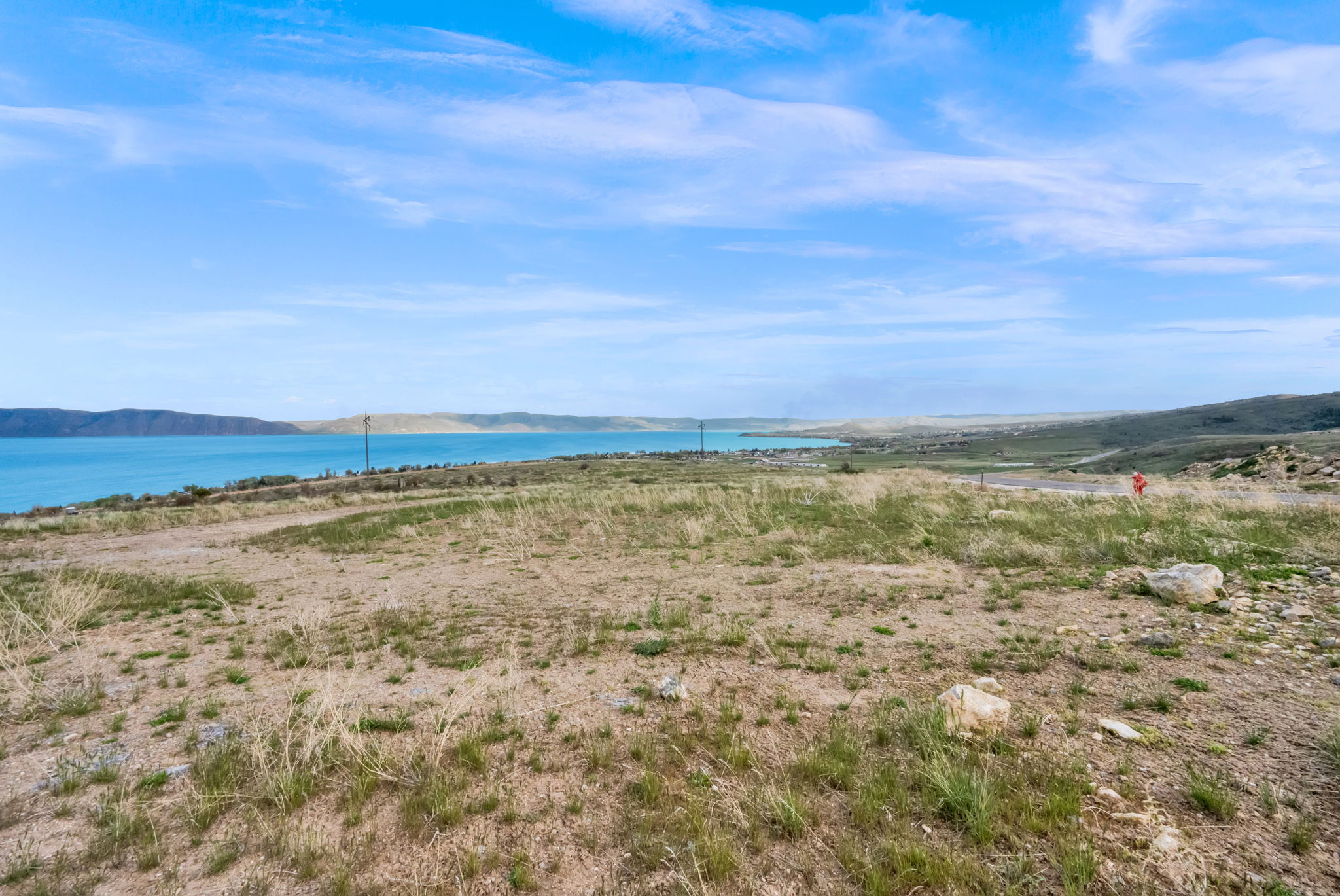 Expansive undeveloped land featuring natural terrain and distant water