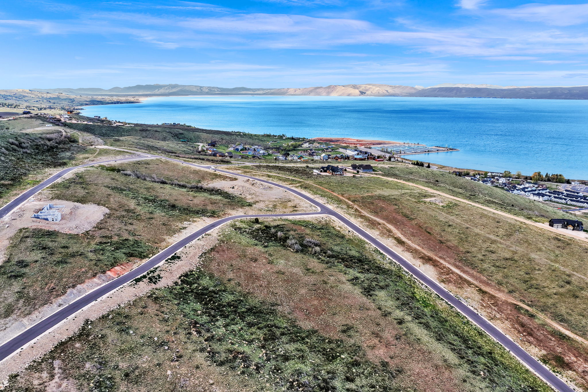 Expansive undeveloped land with paved roads and distant lake frontage