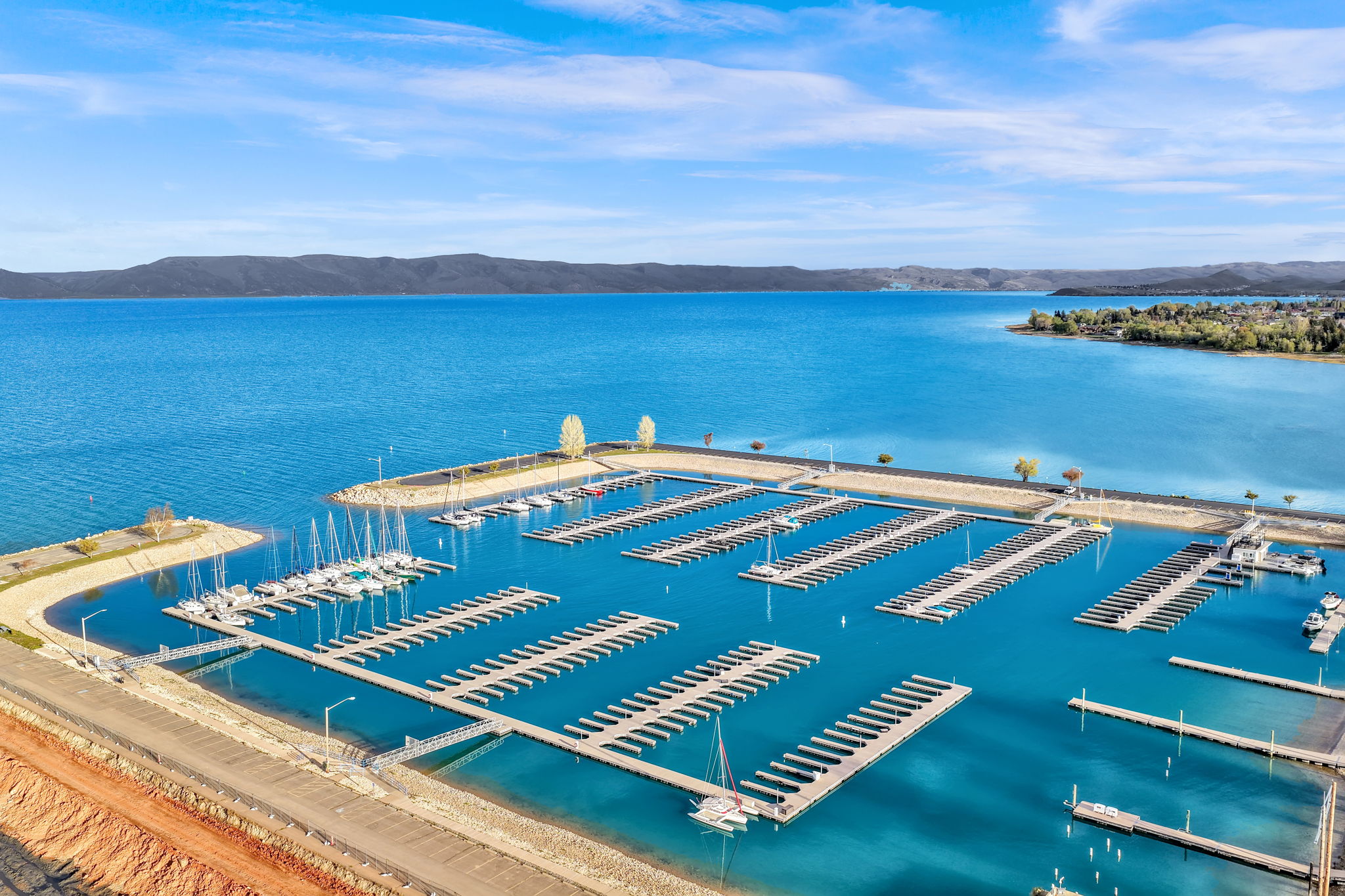 Expansive marina featuring multiple boat slips and deep blue water