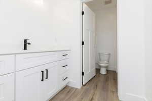 Bathroom featuring vanity and light wood-style floors