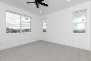 Spare room with carpet flooring, a ceiling fan, and recessed lighting